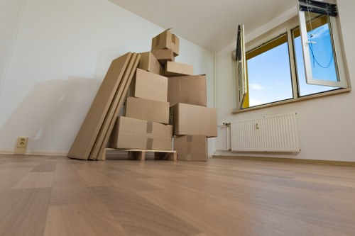 Mover wearing PPE while carrying furniture carefully through a property