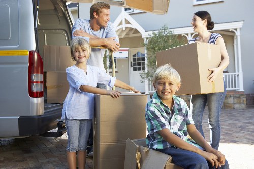 Local movers handling furniture in a Brixton flat